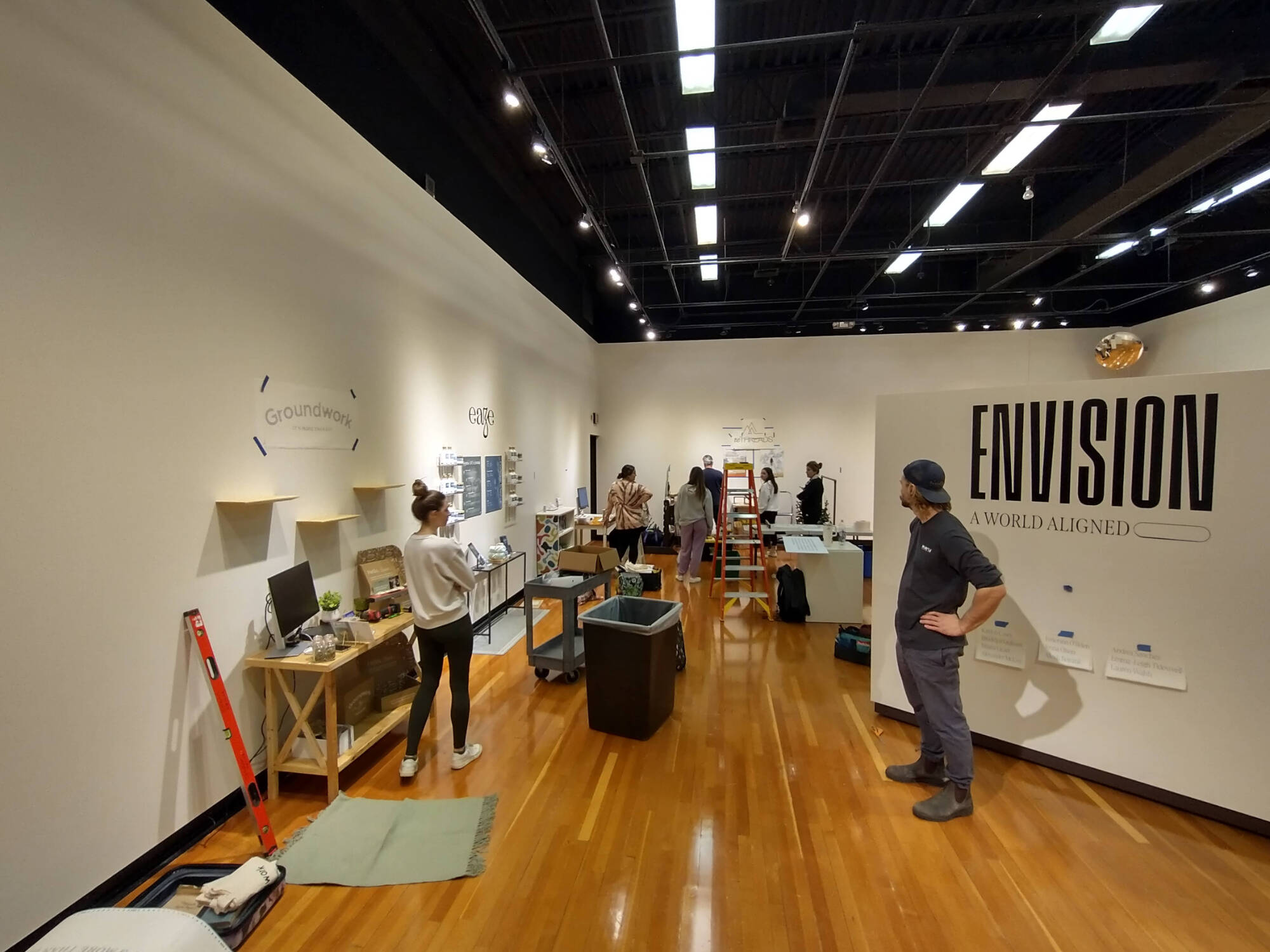 A photograph of students setting up an exhibition in a gallery